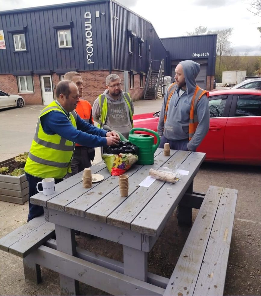 Staff planting outside the Promould building for Earth Day
