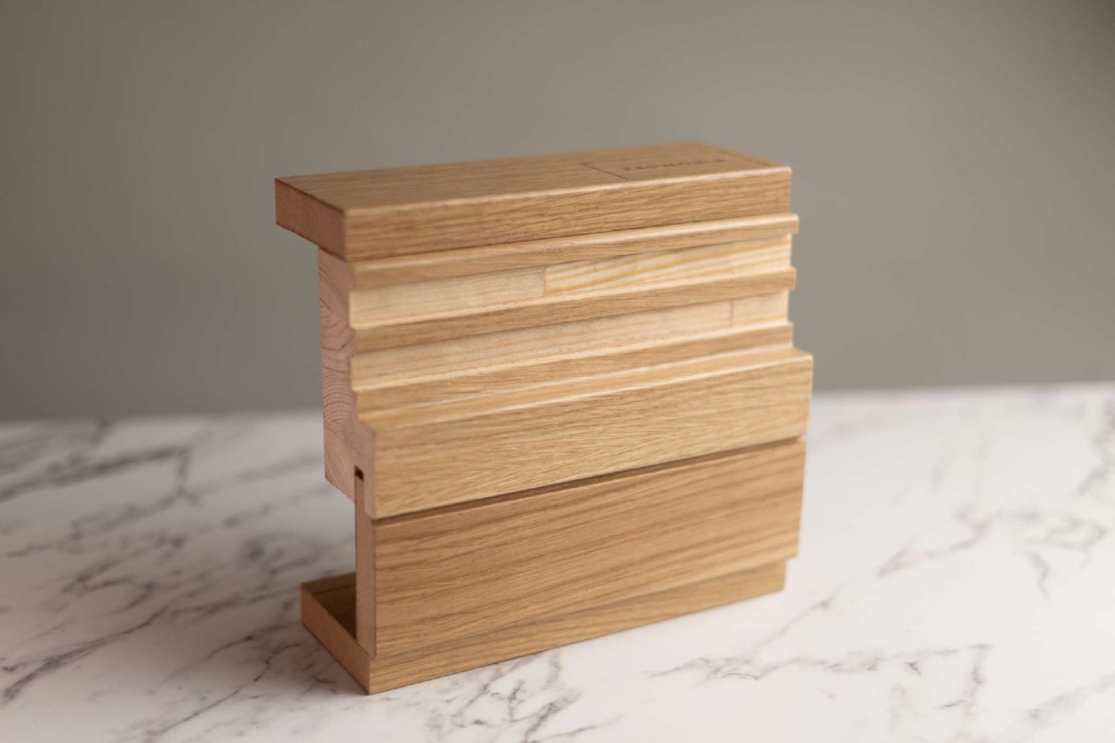 Oak veneered mouldings stacked on marble
