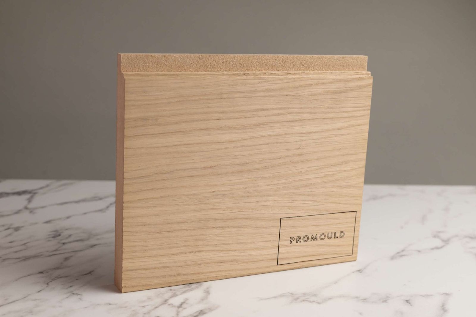 Oak veneered skirting sample with a Promould branded label