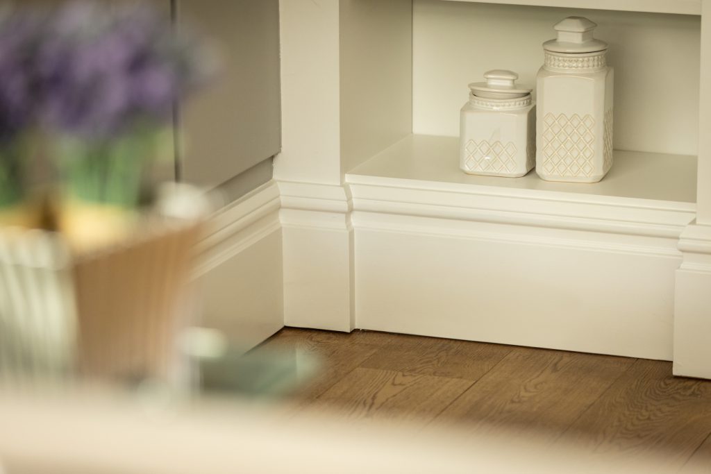 White painted skirting fitted beneath built-in shelving