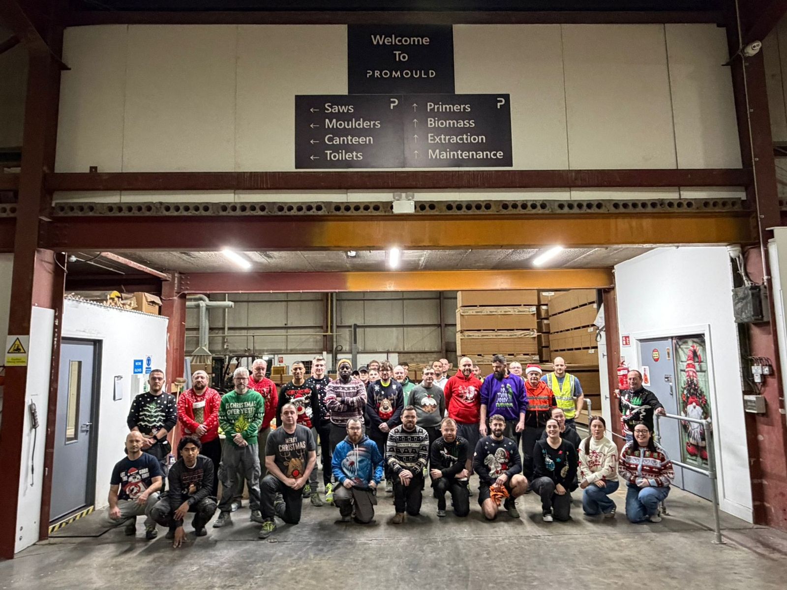 The Promould team in Christmas jumpers in the factory